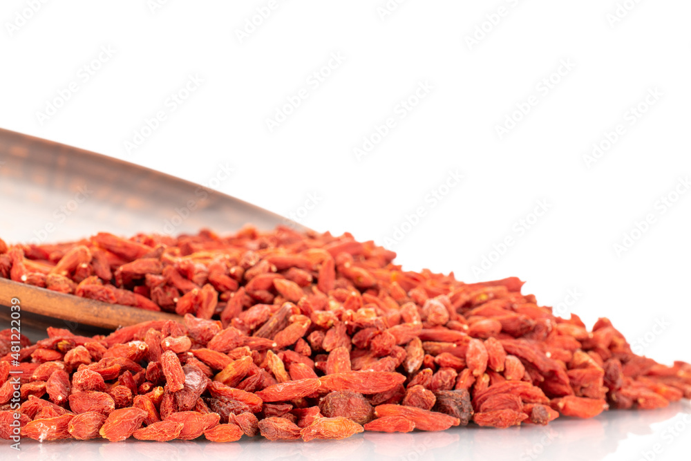 Dried sweet goji berries on a clay dish, macro, isolated on white.