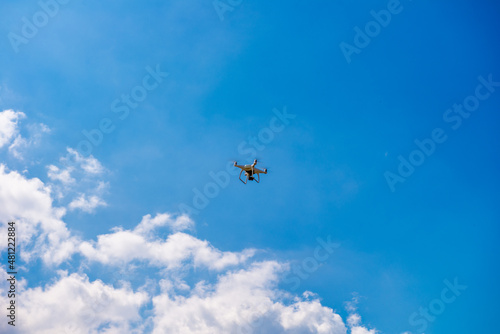 Flying drone in the blue sky. Technology concept.
