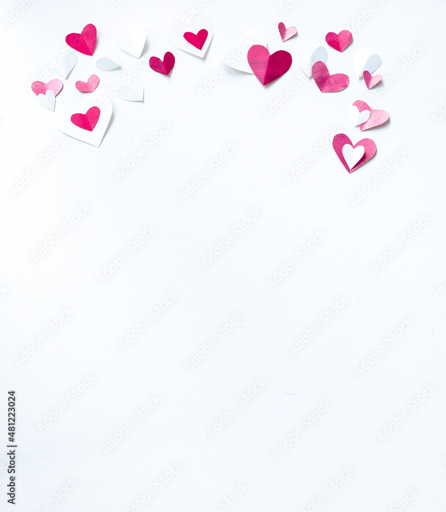 Valentines Day or wedding, invitation, scattered painted small cut out red, pink and white hearts vertical with copy space