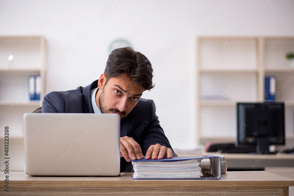 Young male employee working in the office Young male employee working in the office