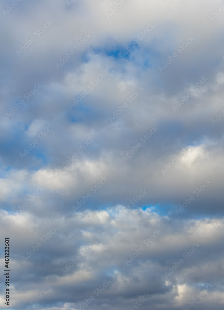 White fluffy clouds densely cover the blue sky