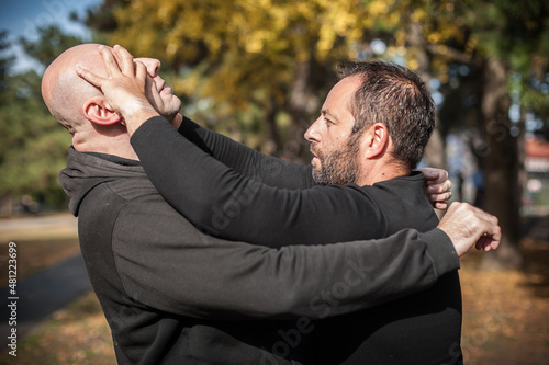 Street fighting self defense technique against holds and grabs photo