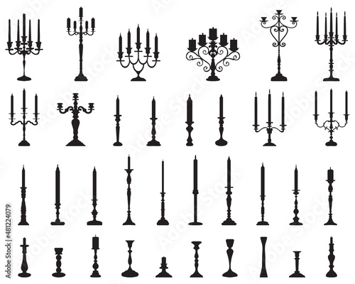 Black silhouettes of candlesticks on a white background