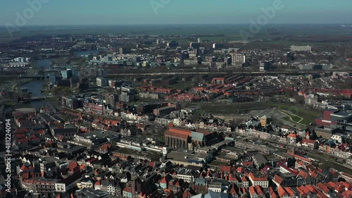 Aerial top view of a city in Holland, surrounded by houses, green trees and canal photo