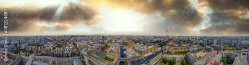 Panoramic aerial view of Berlin skyline at sunset with major city landmarks along Spree river, Germany from drone in summer season.