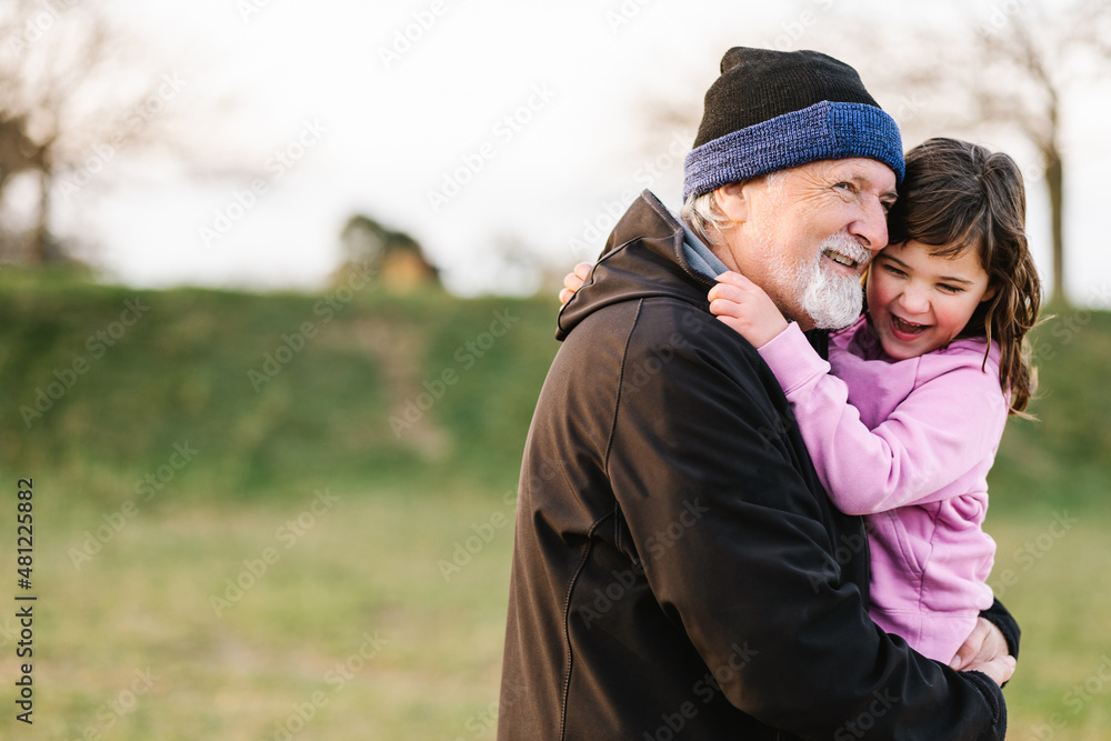 Grandfather hugging girl on street Grandfather hugging girl on street