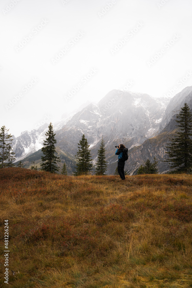 Traveler taking picture of mountains Traveler taking picture of mountains