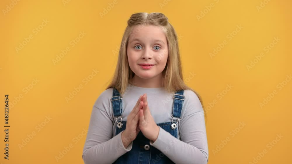 Closeup portrait female kid posing with shocked face expression hands near mouth isolated on orange Closeup portrait female kid posing with shocked face expression hands near mouth isolated on orange