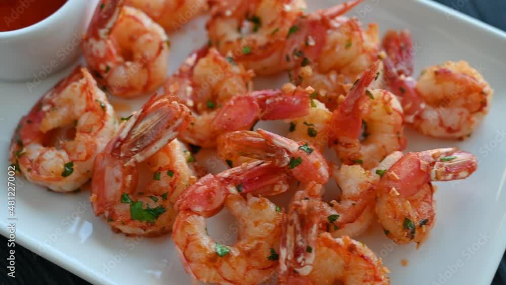 Fried shrimps with greens salt lemon and sauce on the plate Fried shrimps with greens salt lemon and sauce on the plate