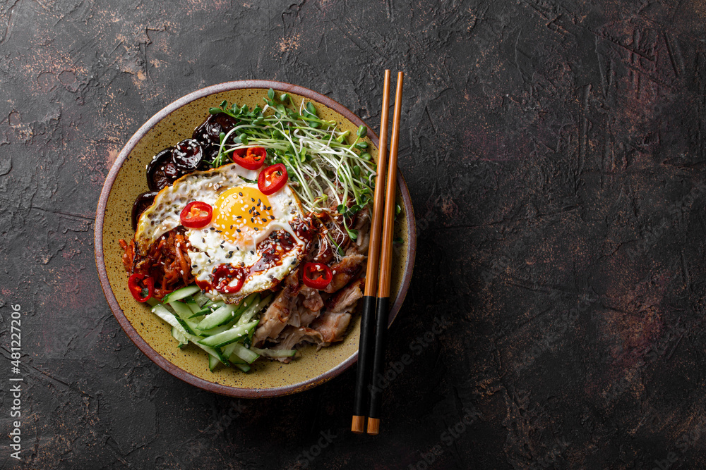 Traditional Korean dish Bibimbap. Bowl with rice, shiitake mushrooms