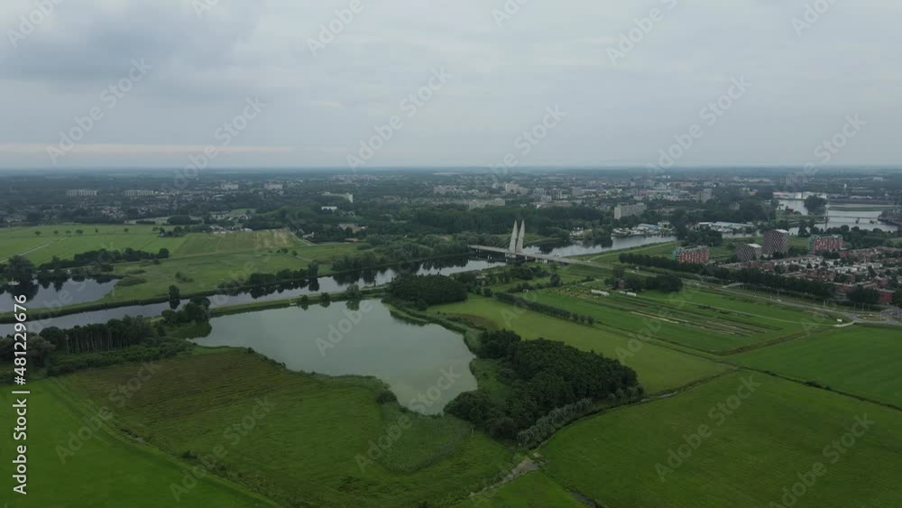 Aerial top view of a city in Holland, surrounded by houses, green trees and canal Aerial top view of a city in Holland, surrounded by houses, green trees and canal