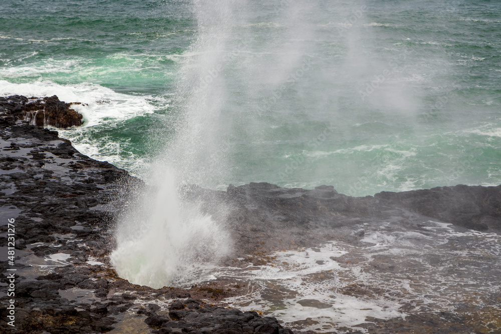Spouting Horn Park on Kauai Island, Hawaii. Water being sprayed out of the Spouting Horn an old volcanic lava tube Spouting Horn Park on Kauai Island, Hawaii. Water being sprayed out of the Spouting Horn an old volcanic lava tube