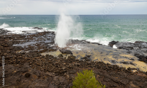 Spouting Horn Park on Kauai Island, Hawaii. Water being sprayed out of the Spouting Horn an old volcanic lava tube