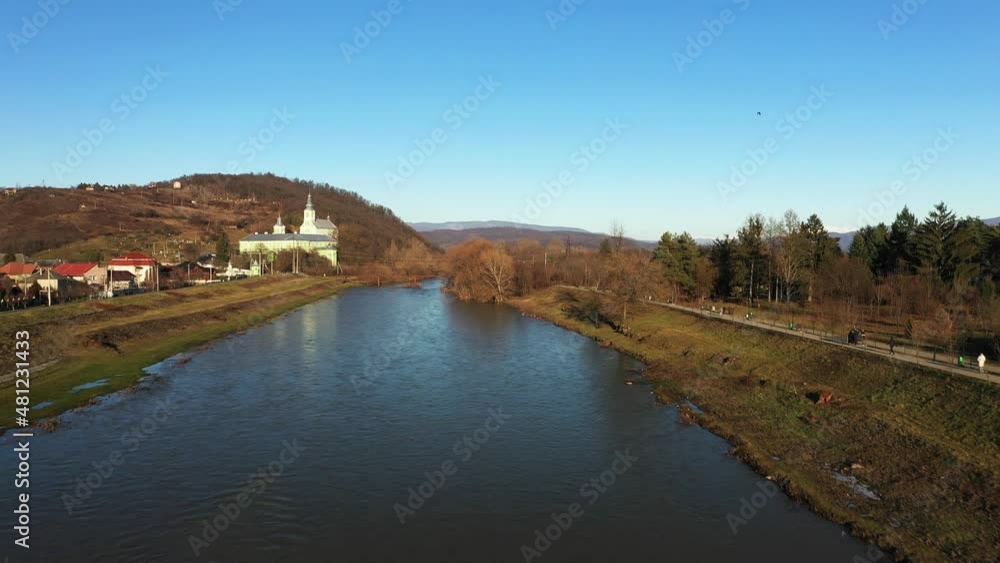 The Mukachevo city near the river in the park with beautiful mountains aerial view The Mukachevo city near the river in the park with beautiful mountains aerial view