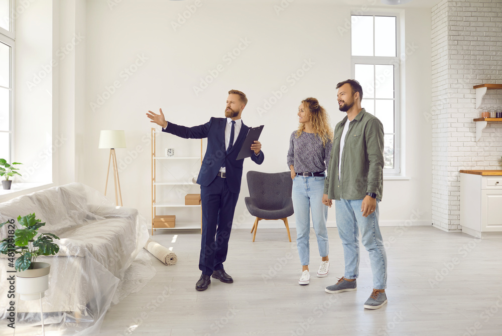 © Studio Romantic - Realtor or real estate agent giving potential buyers or tenants tour about big house. Boyfriend and girlfriend or husband and wife who consider buying property looking at new modern spacious home © Studio Romantic - Realtor or real estate agent giving potential buyers or tenants tour about big house. Boyfriend and girlfriend or husband and wife who consider buying property looking at new modern spacious home