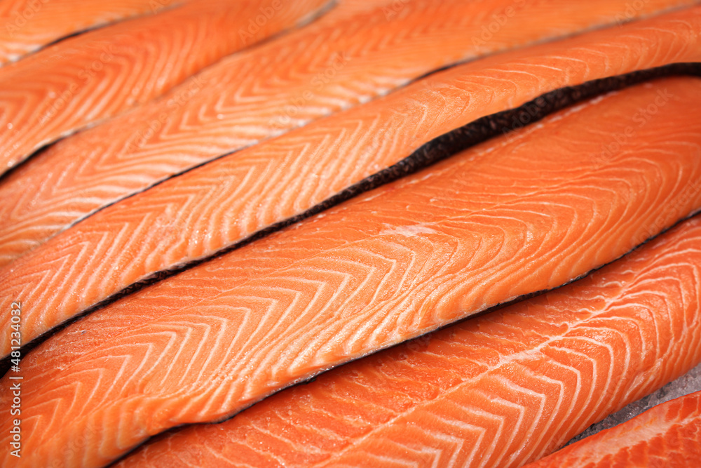 Cooled salmon fillets layout on a showcase of supermarket