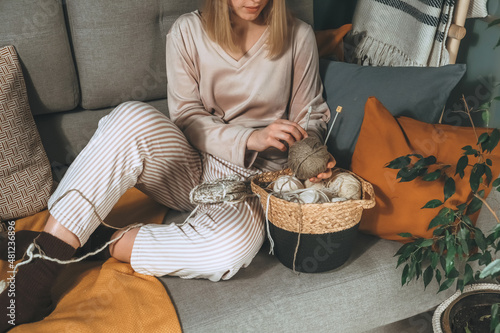 Girl knitting at home.Handmade zero waste,upcycling,New small business employment opportunity concept.Hobby knitting and needlework for mental health.Knitted background photo