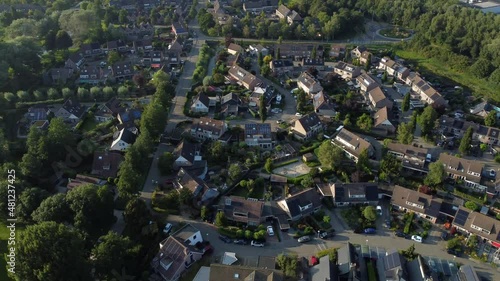 Aerial top view of a city in Holland, surrounded by houses, green trees and canal