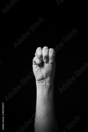 B+W image of hand demonstrating Chinese sign language letter M isolated against black background