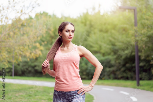 Fototapeta Naklejka Na Ścianę i Meble -  Beautiful athletic woman standing running track in summer park Portrait caucasian female jogger outdoor