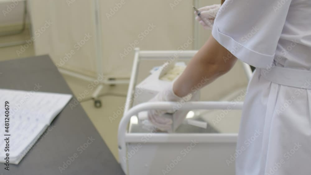 Close-up of the hands of a female doctor preparing a vaccine for injection Close-up of the hands of a female doctor preparing a vaccine for injection