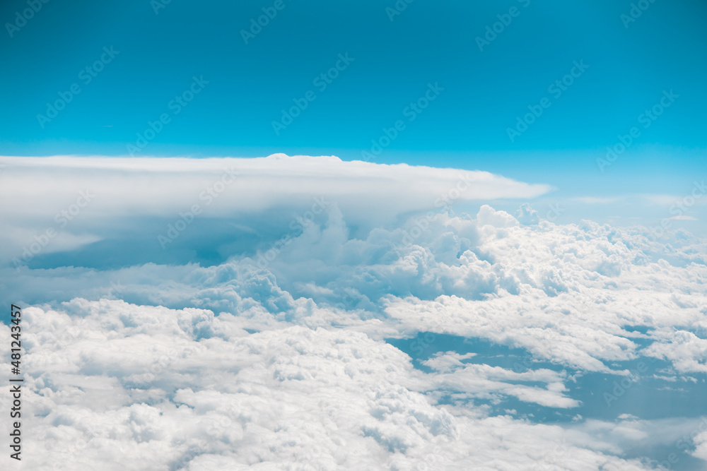 White puffy clouds taken from a moving airplane. Blue skies above. Flying in air. Plane ride travel. High quality photo White puffy clouds taken from a moving airplane. Blue skies above. Flying in air. Plane ride travel. High quality photo