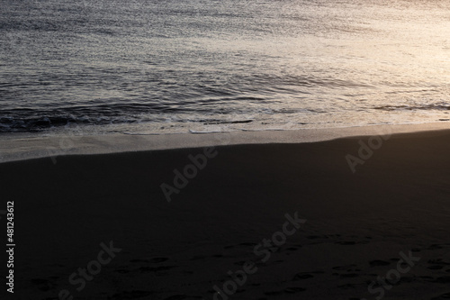 Black sand beach with sunset light