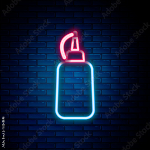 Glowing neon line Mustard bottle icon isolated on brick wall background. Colorful outline concept. Vector