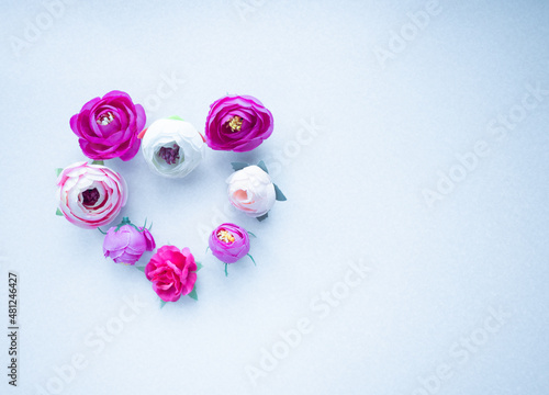 Heart laid out from flowers on a white background