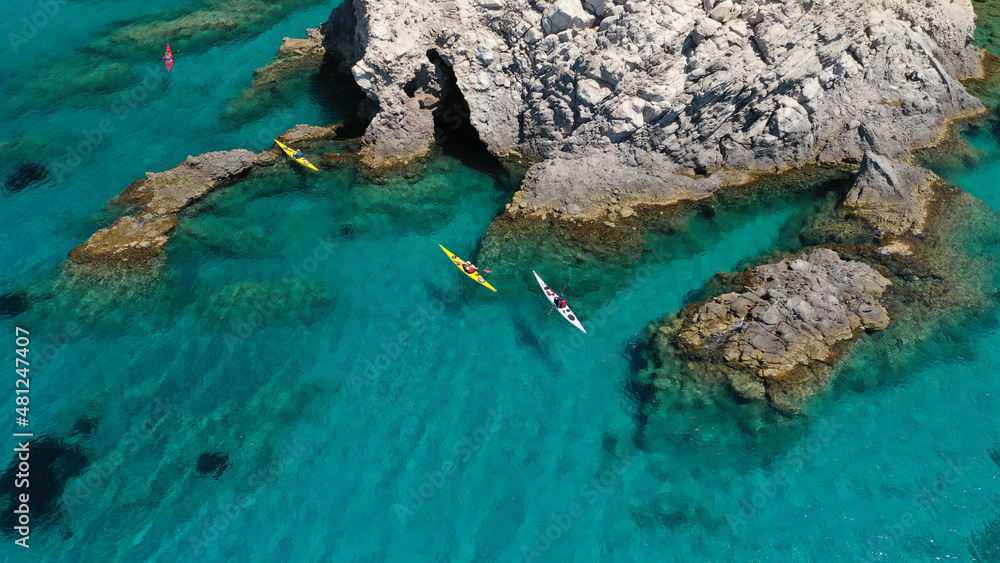 Aerial drone photo of women athletes rowing in sports kayak in tropical Caribbean exotic destination with turquoise calm sea