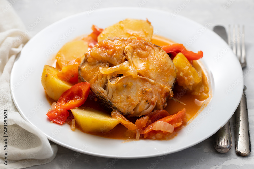 typical portuguese fish stew on white plate