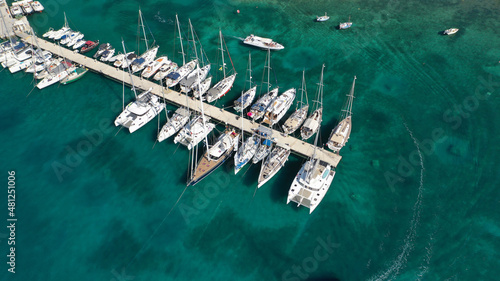 Aerial drone photo of picturesque village of Adamantas main port a natural calm sea bay and safe anchorage of yachts and sail boats in volcanic island of Milos, Cyclades, Greece photo