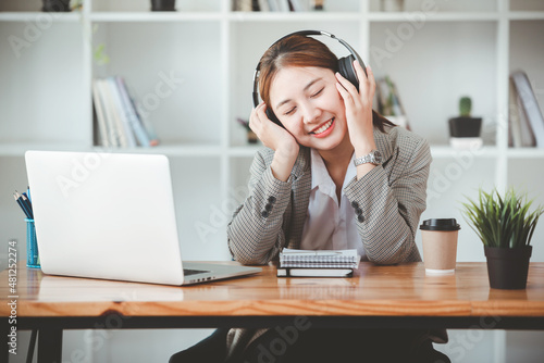 young business woman wearing headphones enjoy listening to music