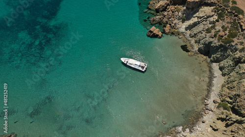 Aerial drone photo of inflatable rib boat anchored in beautiful beach of Kalogria with emerald crystal clear sea, Milos island, Cyclades, Greece