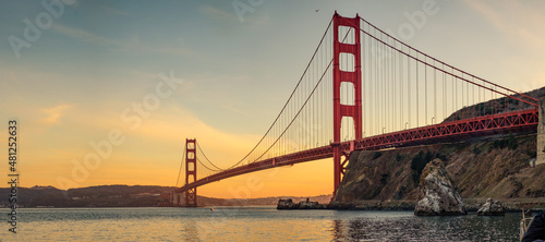 A panoramic view of a golden bridge at sunset in San Francisco