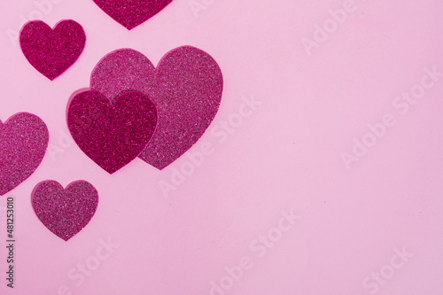 Heart shapes with glitter in different colors on a purple background in combination with ring box  chocolate or red rose. Nice and simple Valentine s day or engagement concept 