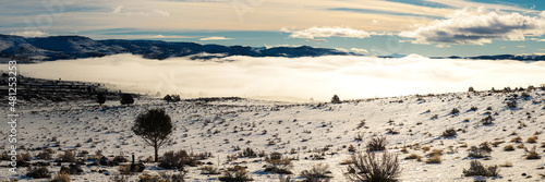 Panoramic image of fog in the Willow Creek Valley of Lassen County, California, USA. Photographed from above as late morning sun reflected off the fog.