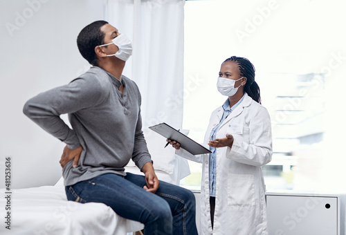 What other symptoms have you had. Shot of a doctor having a consultation with a patient suffering from back pain.