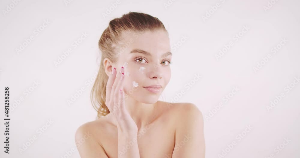 Amazing girl with pure natural skin applying white cream Amazing girl with pure natural skin applying white cream