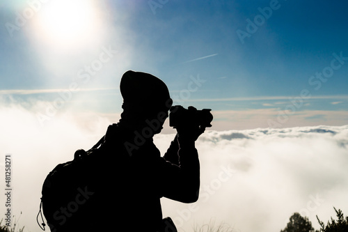 silhouette of a person with a camera