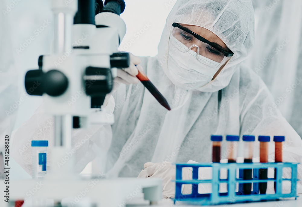 Fototapeta premium The answers are in the details. Shot of a scientist in hazmat suit conducting medical research in a laboratory.