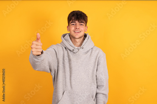 isolated teen boy with okay or approval sign