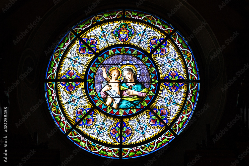 The famsous Cathedral of Saint Lawrence in Lugano and its stained glass rosette of Virgin Mary with baby Jesus, Lugano, Switzerland