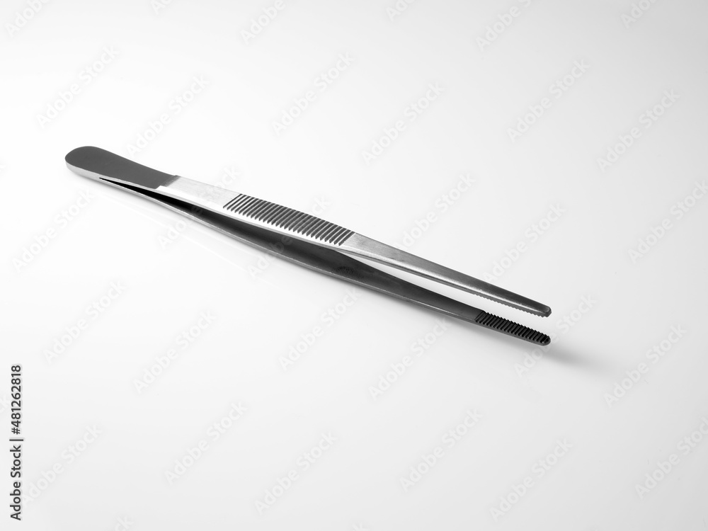 Stainless steel medical tweezers on a white background. Stainless steel medical tweezers on a white background.