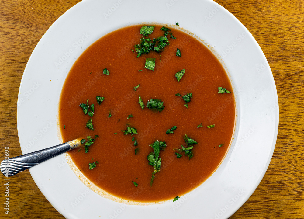 bowl of tomato soup with parsley bowl of tomato soup with parsley