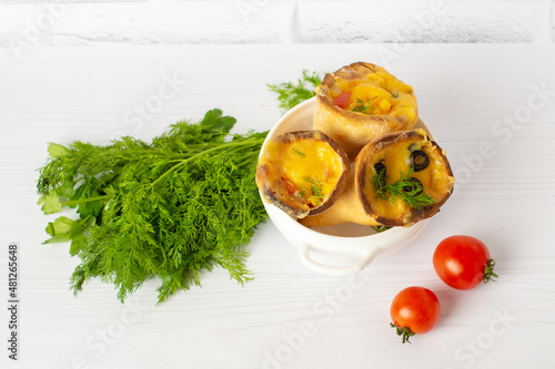 Organics and delicious pizza cones with a crunchy thin crust, lots of melted cheese, fresh vegetables and fine spices photo