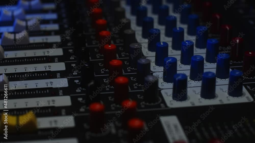 The sound engineer controls the sound volume using faders The sound engineer controls the sound volume using faders