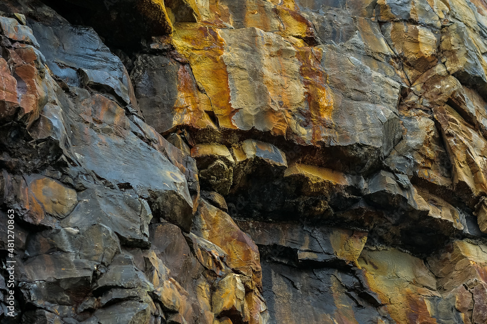 Fototapeta premium Colorful stone texture background. Rock surface of a mountain