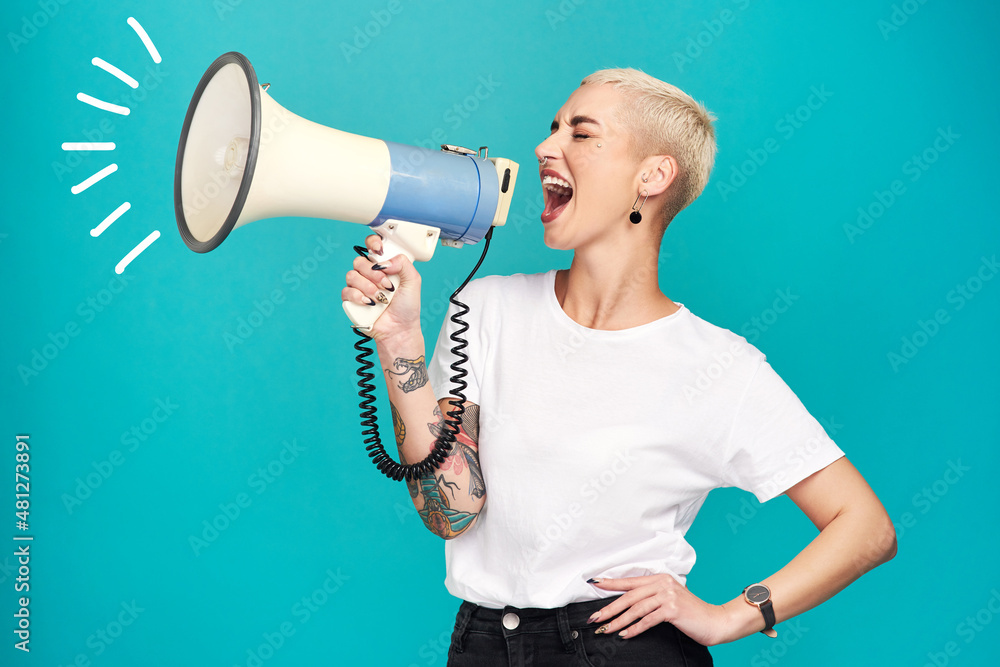 I will not be silenced. Studio shot of a young woman using a megaphone against a turquoise background. - obrazy, fototapety, plakaty 