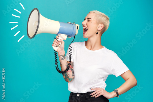 I will not be silenced. Studio shot of a young woman using a megaphone against a turquoise background.